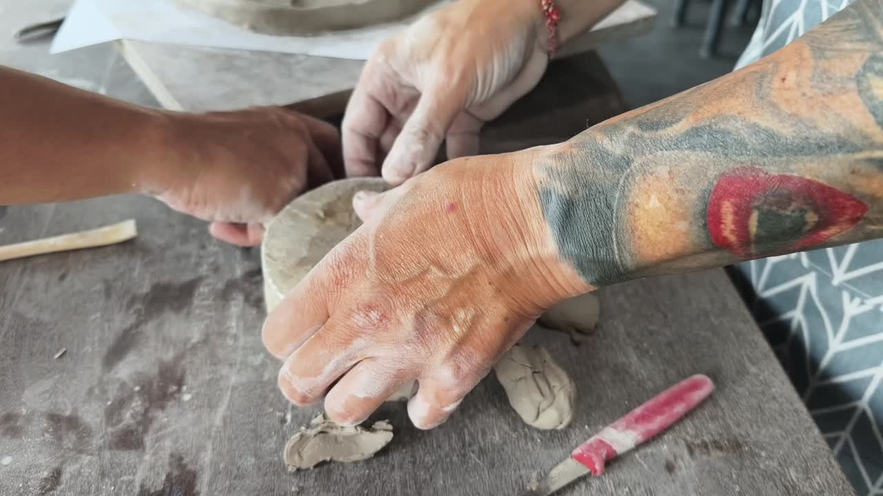 Close Up of Hands Shaping Clay in a Pottery Workshop