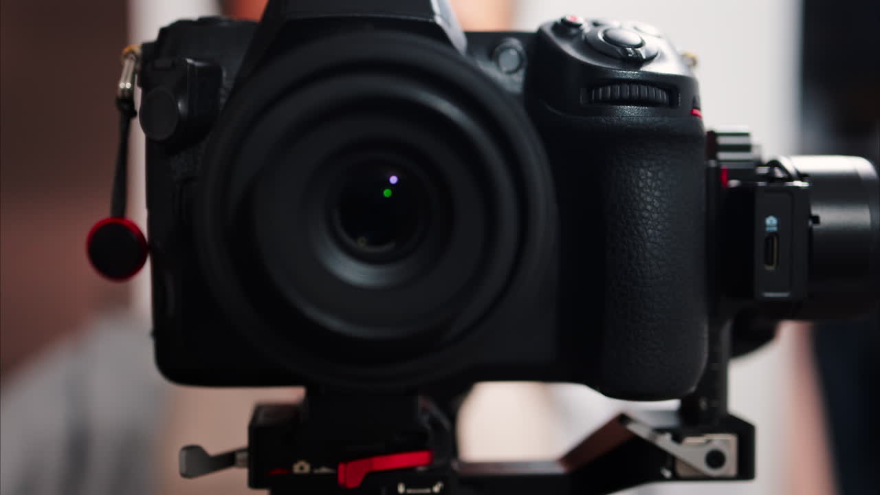 Close up of a professional black camera on a blurry background