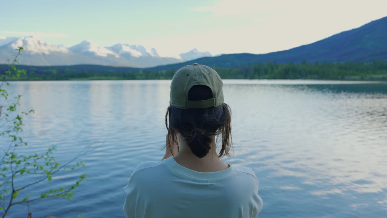 Woman capturing Pyramid Lake scenery in Jasper National Park, Canada