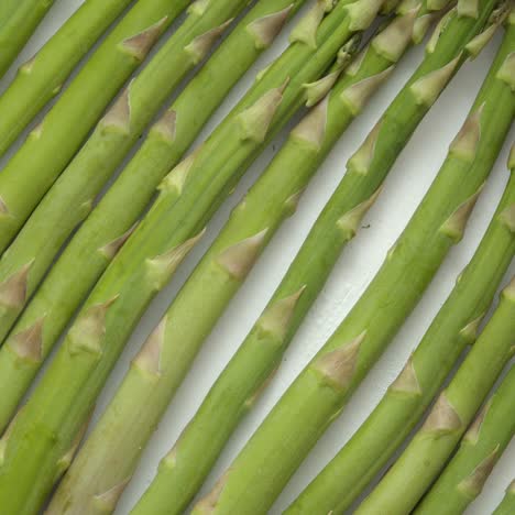 Green-fresh-and-healrhy-asparagus-placed-on-a-white-wooden-table--Top-view--Close-up-