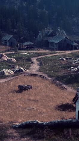 a peaceful rural scene with farmhouses, barns, and a dirt road leading to a forest