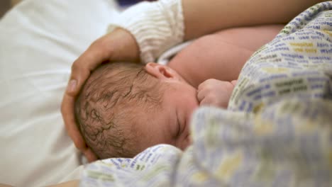 newborn baby suckling for the first time while being cradled lovingly by their mother, showcasing the precious beginnings of life