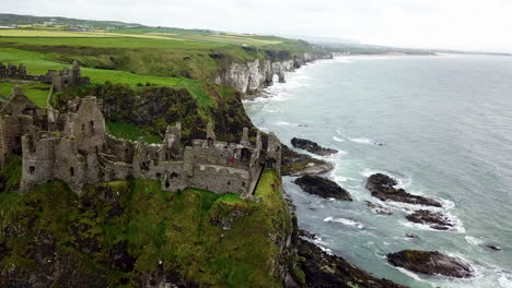 cinematic aerial view of coastline near dunluce castle