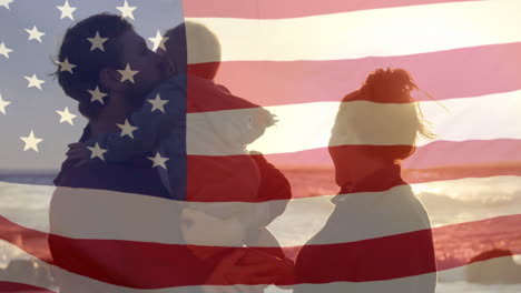 animación de la bandera de américa sobre padres caucásicos con un niño en la playa