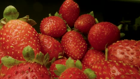 macro slide ripe juicy strawberry. healthy organic food. the camera moves through a heap of strawberries. dolly shot using a probe lens. red berries. close-up. type c.