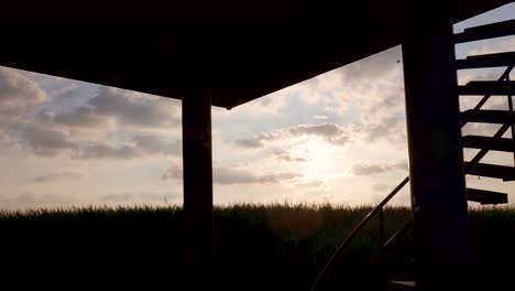 silhouetted structure against sunset sky