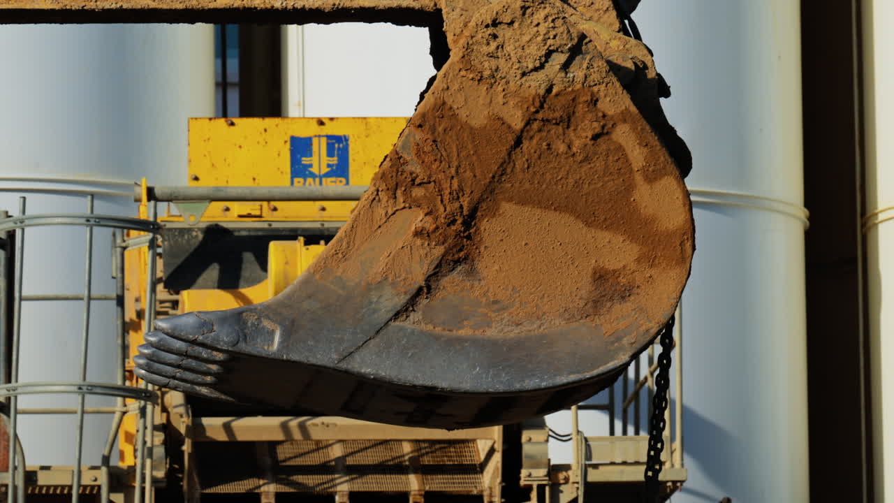 Close up of a yellow crane machine moving and lifting on a construction site