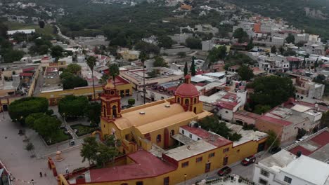 drone orbit of peña de bernal church in queretaro