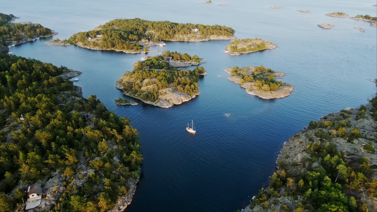 Drone of peaceful island archipelago, revealing lush greenery, deep blue waters