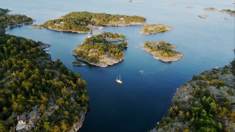 drone of peaceful island archipelago, revealing lush greenery, deep blue waters