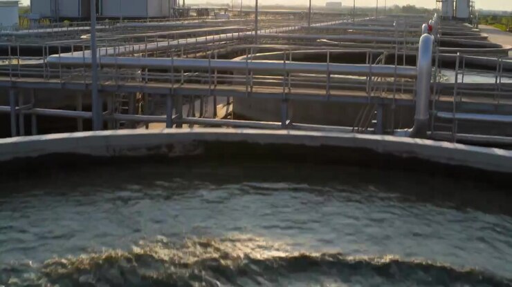 Churning aerator forming upwelling in front circular basin at treatment plant, aiding aeration