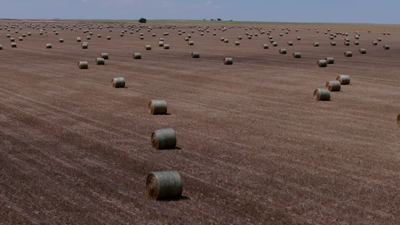 Aerial pullback reveal of expansive agricultural field stretching across the breadbasket of America