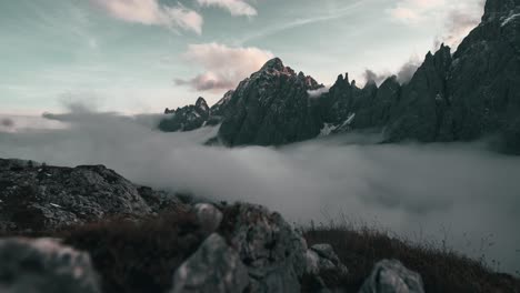 fog is rising up a pristine mountain valley in the italian alps during sunset