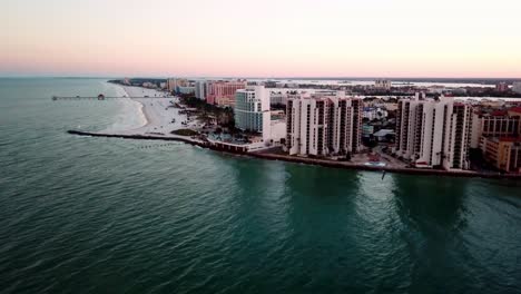 high aerial push in high rises along clearwater beach florida at sunrise