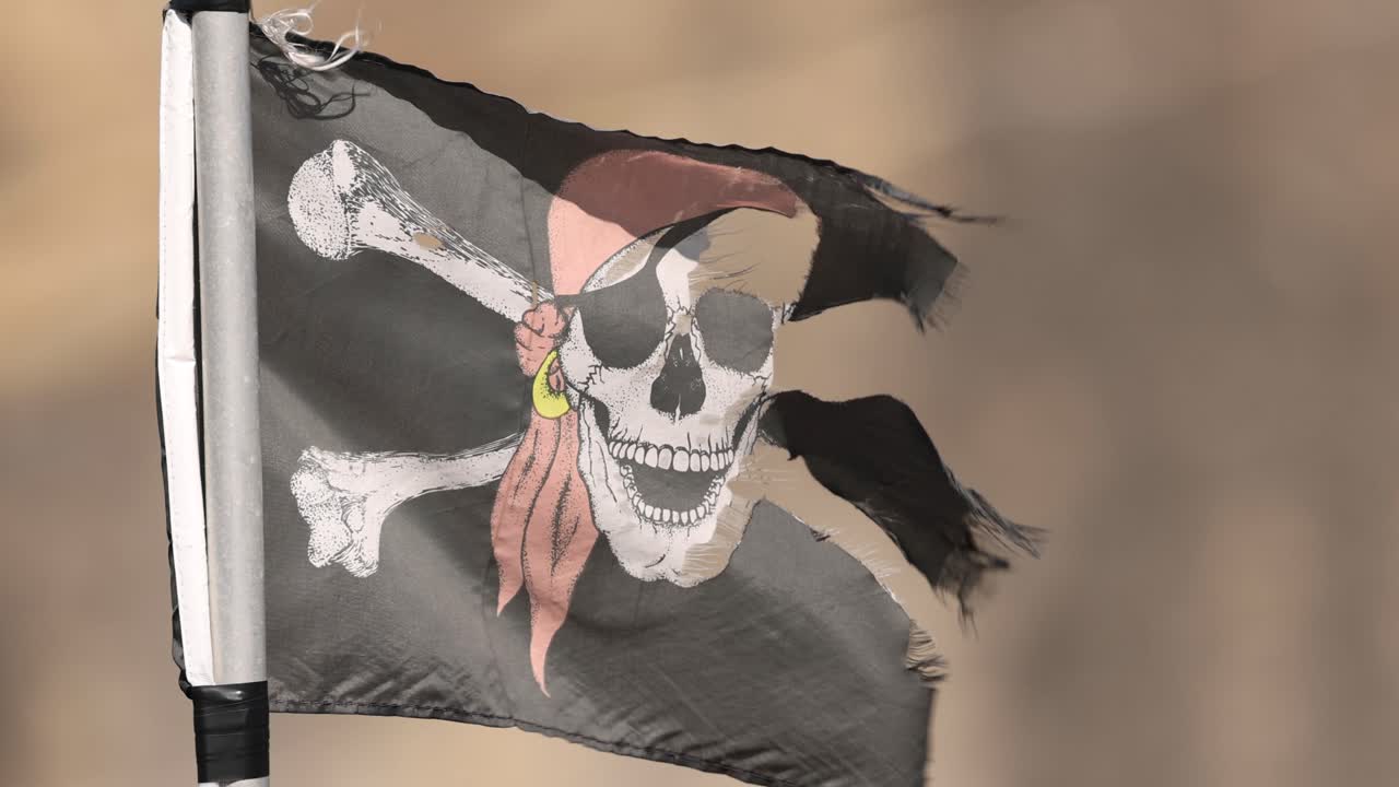 la bandera de jolly roger flota en una fuerte brisa.