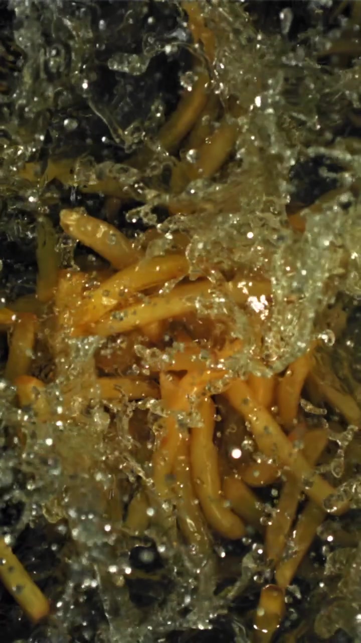 Golden French Fries Deep Frying in Hot Bubbling Oil