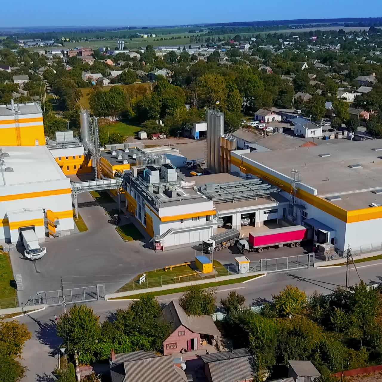 Nice territory of a new industrial plant located in the rural area. Drone footage over the landscape on sunny day