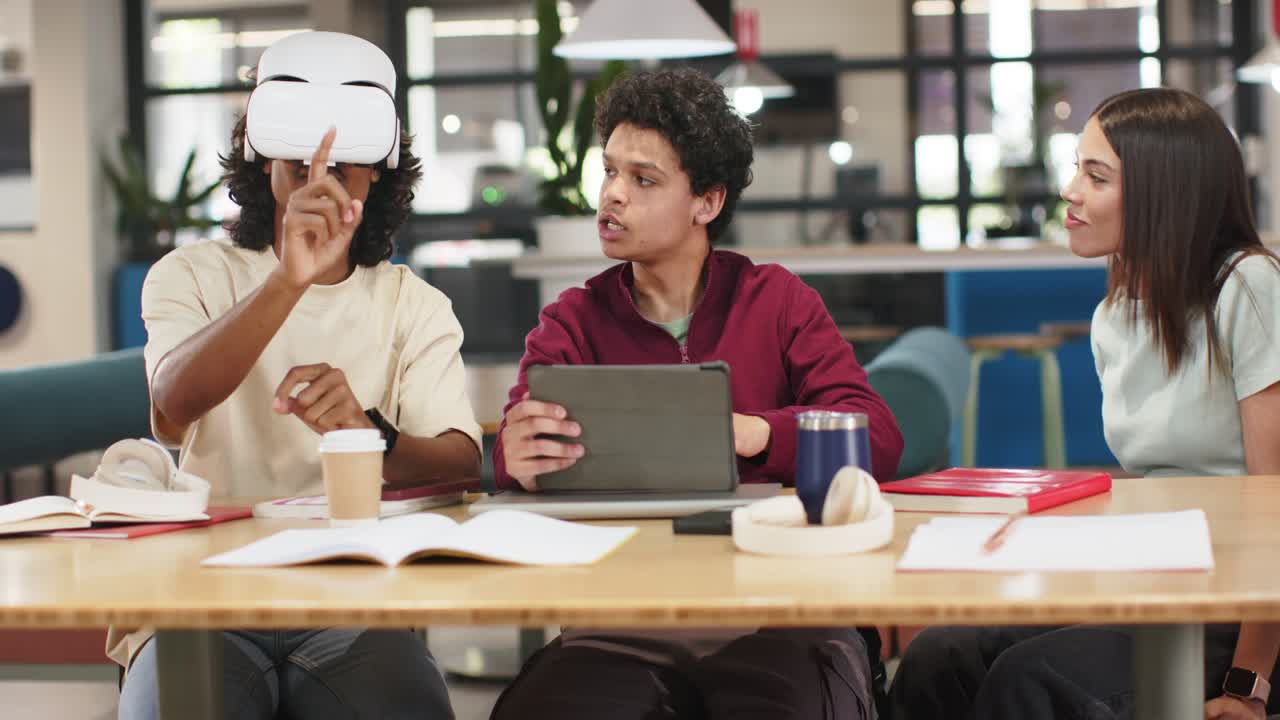 African American students wearing white VR headset pointing while tablet user guiding study at hub