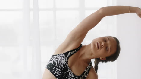 beautiful caucasian woman practicing yoga seated side bend pose meditation enjoying healthy lifestyle at home stretching flexible body