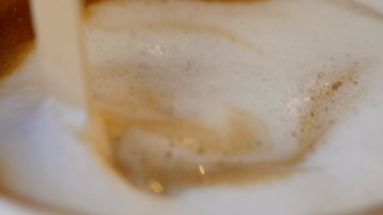 Pouring Milk into Coffee: Latte or Cappuccino Preparation
