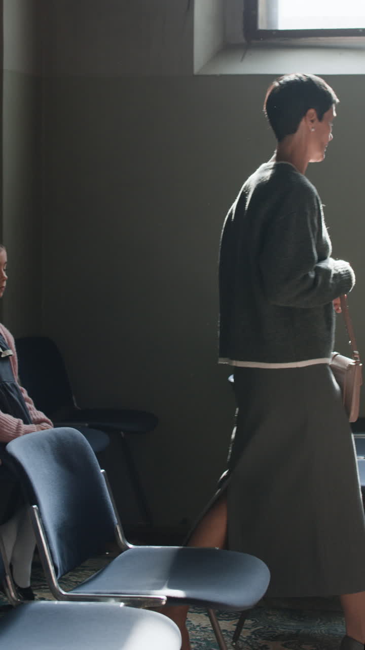 People in a room with chairs