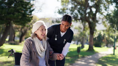 nurse helping elderly woman walk in park