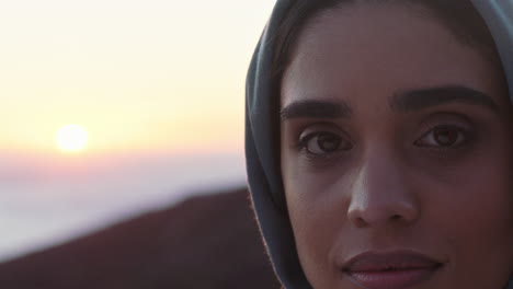 close up portrait of beautiful muslim woman looking contemplative exploring spirituality feeling peaceful enjoying sunset wearing hijab headscarf