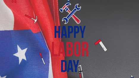 animation of happy labor day text over tools and american flag