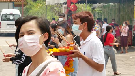 asian people praying and doing worship ceremony in chinese temple