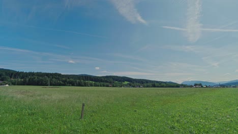 static shot over austrian field with mountains in the background