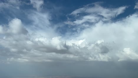 nice pilot view flying just bellow some clouds in a summer hazy sky