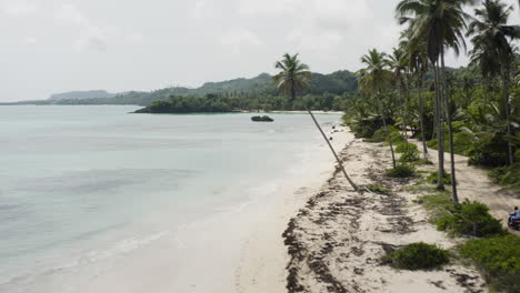 long stretch of white sand and calm water at playa rincon in samana, dominican republic