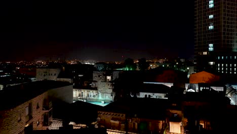 Las-Luces-De-La-Ciudad-De-Jerusalén-Se-Revelan-Por-La-Noche,-Toma-Aérea