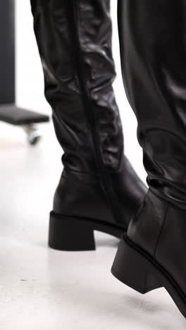 indoor lady shoes showroom. stylish footwear shop trying concept. vertical video