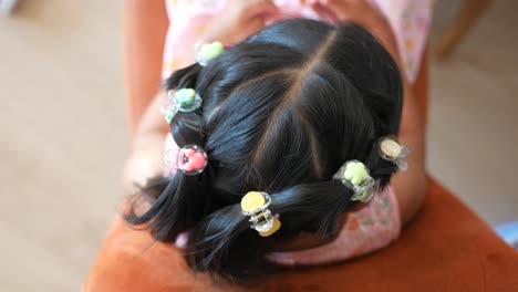 little girl with cute hair clips in her hair.