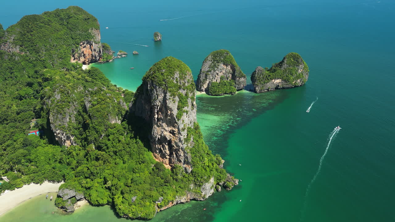 Aerial circling limestone cliff at Railay beach in sunny day, Thailand