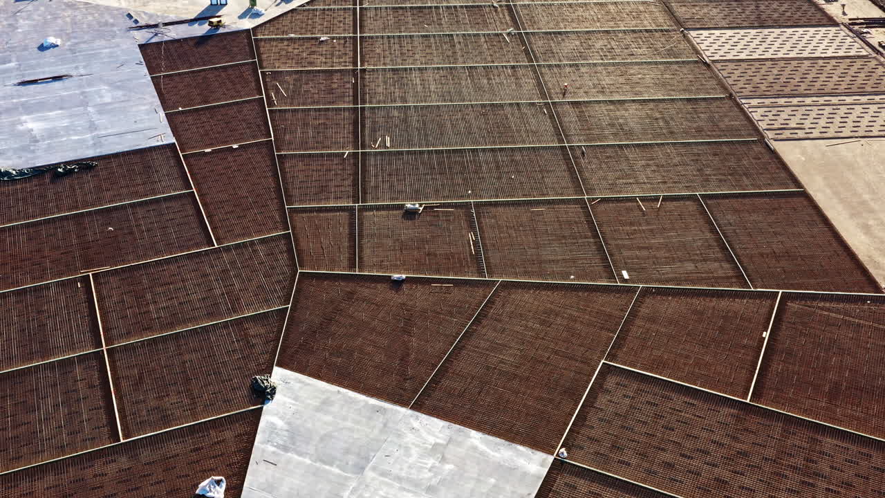 Drone view over industrial foundation with exposed rebars and protective sheeting