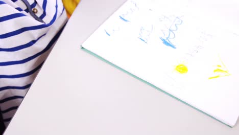 a child drawing on notebook