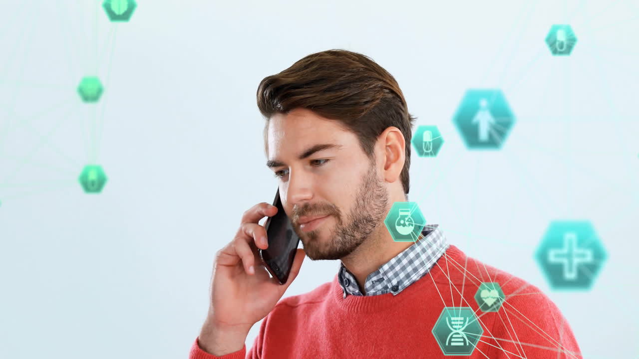 Animation of connected icons globe over caucasian man standing and talking on smartphone