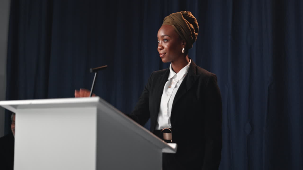 Woman Giving a Speech at a Conference