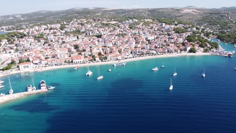 primosten, dalmatia, croatia - aerial drone view of beaches, sail boats, village and coastline