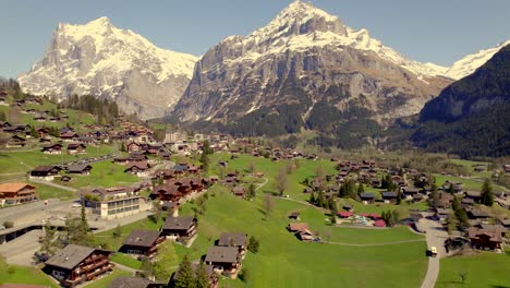 aerial drone footage pushing out over picturesque mountain village grindelwald