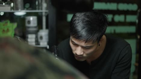 a male artist working with focus in his studio