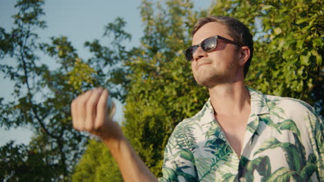 man in tropical shirt outdoors