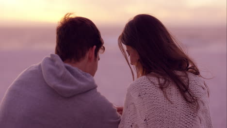 happy romantic couple taking photograph of sunset using mobile phone camera shot on red dragon