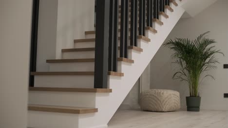 interior design stylish wooden stairs inside the house with modern wooden railings and walls decorated with trendy lamps. modern stairway or staircase inside in modern house interior