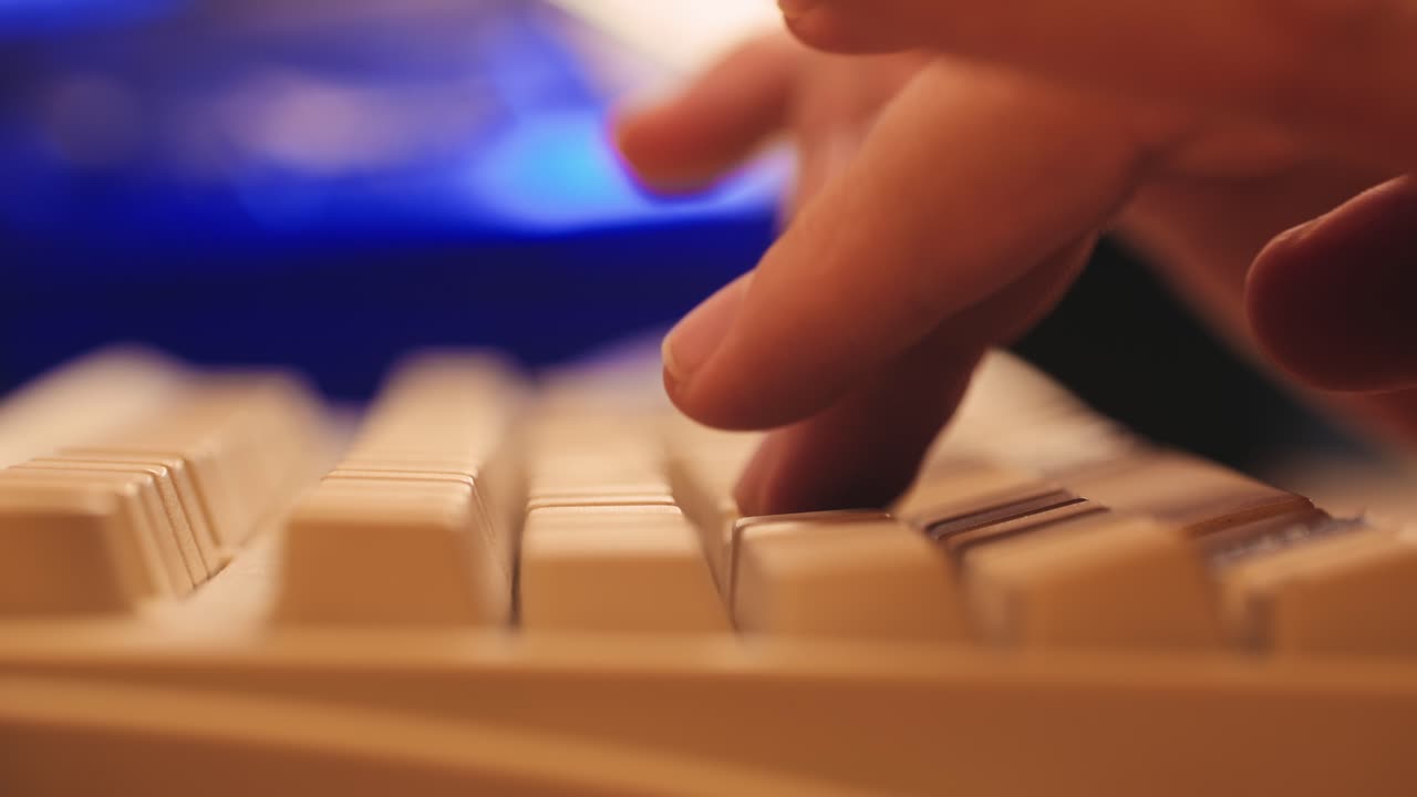 Man working and gaming on retro computer PC, IT engineer with vintage computer at home, using old fashion technology, close up of retro setup.