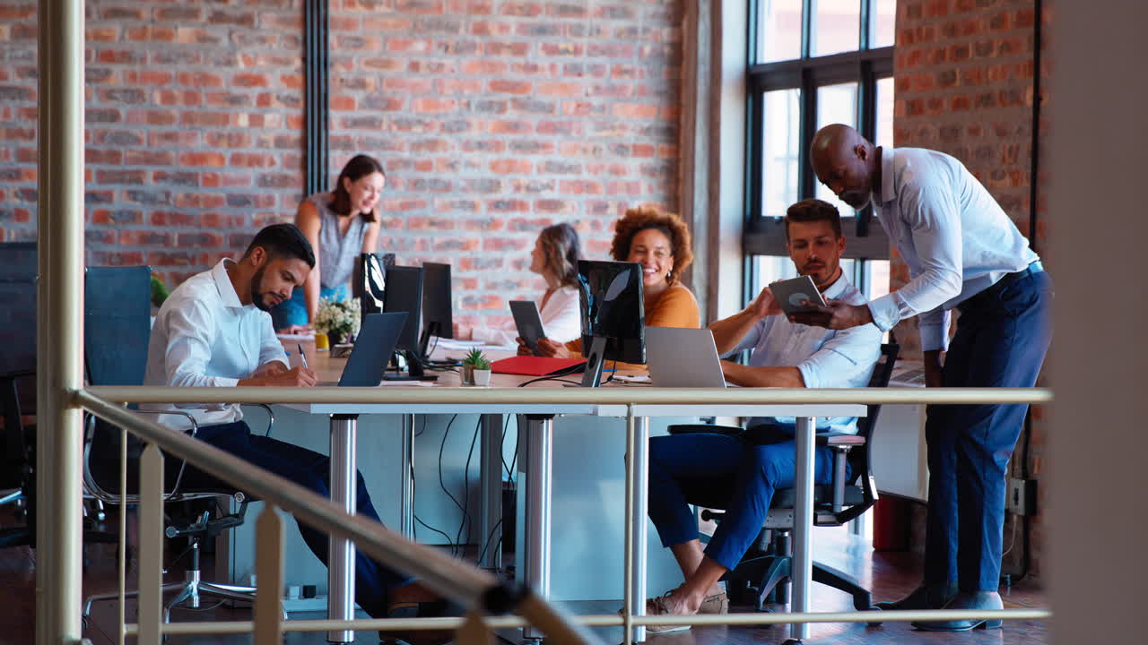 Business Team Working Together In Busy Multi-Cultural Office