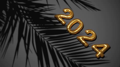 balón de oro 2024 sobre fondo negro de palmeras siluetas