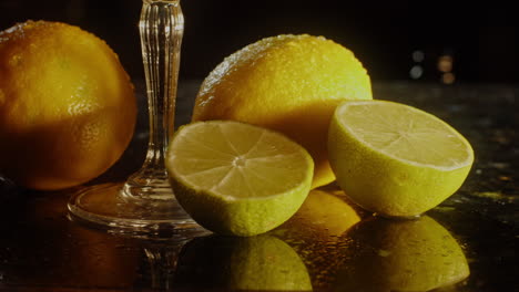 lemons and limes on a dark countertop